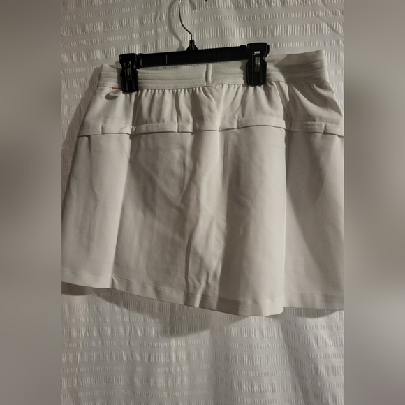 NWT Adidas golf or tennis skort. Front pockets.  White.  Orange logo. Size Small - Picture 2 of 7